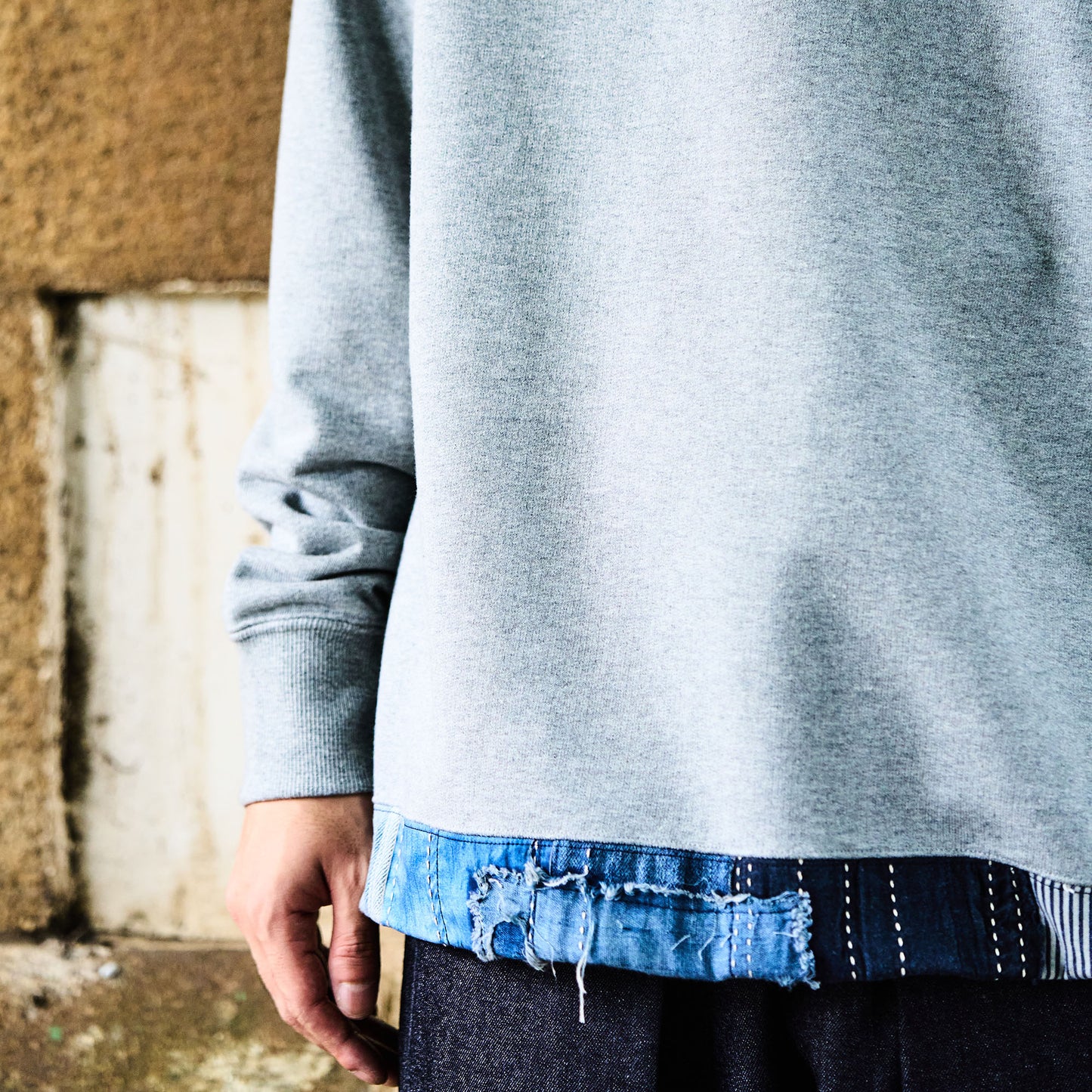 Distressed Denim Trimmed Hem Sweatshirt